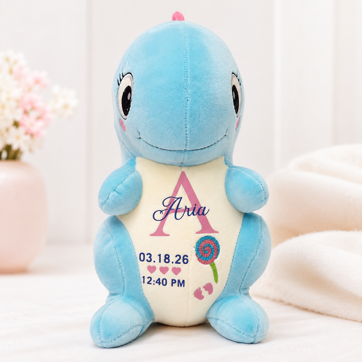 Blue personalized dinosaur plush with baby name and birth details