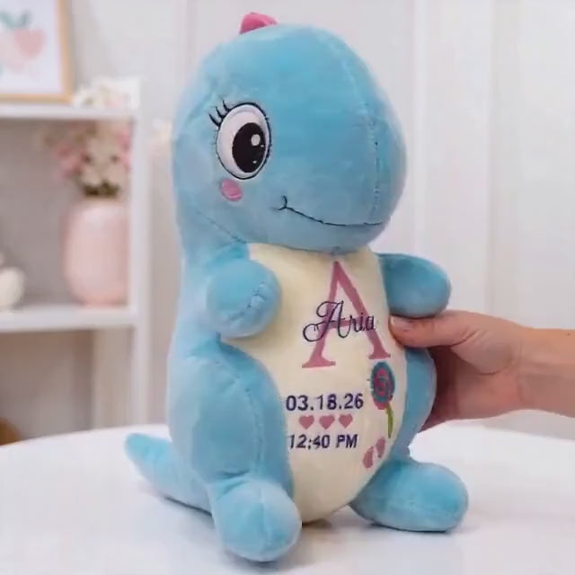 Personalized birth stat dinosaur plush embroidered with a baby's name and birth details