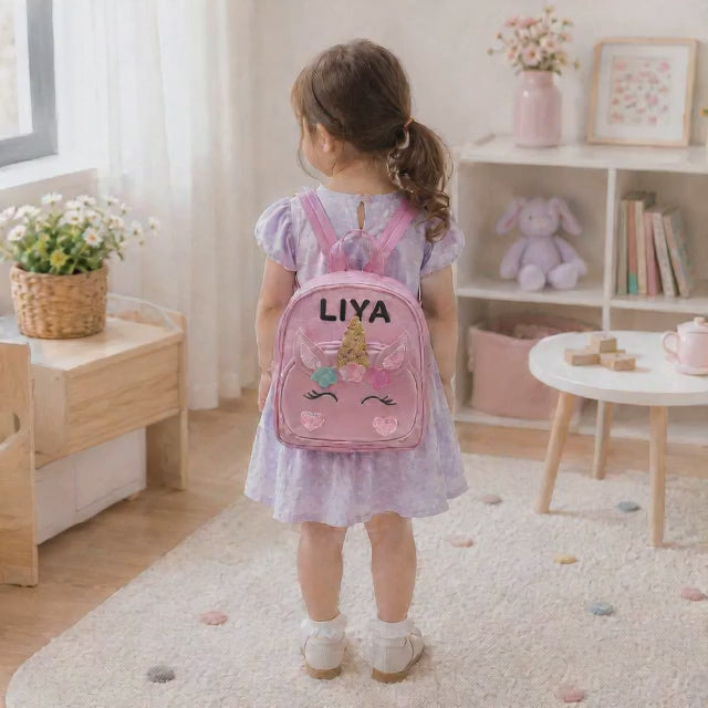Personalized unicorn mini backpack shown with a custom name added to the front